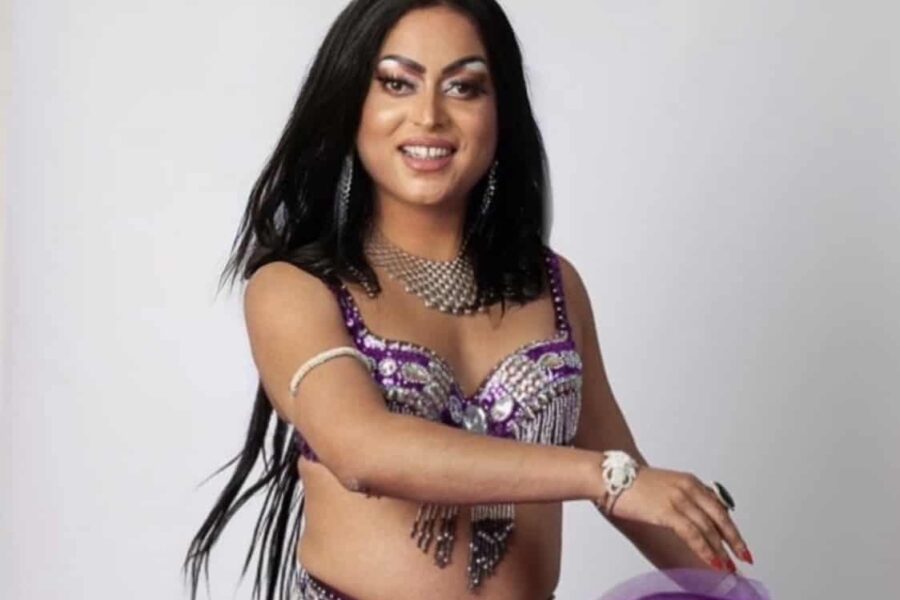Asifa Lahore is in the middle of this image in a silver sequin bra top and a purple skirt potrays movement in the air