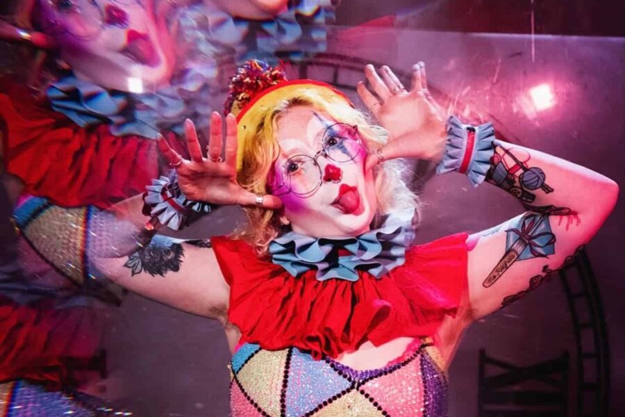 ‘Trailing pom poms and sticky with rainbows, Jiggles uses every performance to spread her sapphic silliness. Sit back and let this big top turn that frown upside clown!